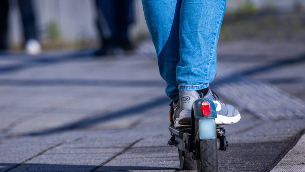 ARCHIV - Ein Mann fährt mit seinem E-Scooter über den Bahnsteig. Foto: Jens Büttner/dpa/Symbolbild