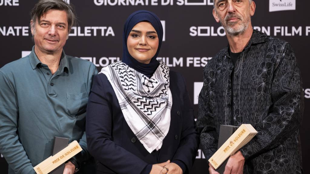 Der Regisseur Nicolas Wadimoff, Gewinner des «Prix de Soleure» mit «Qui vit encore», rechts, Protagonistin Haneen Harara, Mitte, und der Produzent Philippe Coeytaux, links, posieren kurz vor der Preisverleihung der 61. Solothurner Filmtage in Solothurn.