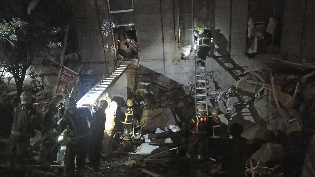 Rettungskräfte in der taiwanesischen Stadt Tainan bergen nach dem Erdbeben Verschüttete aus einem Wohngebäude.