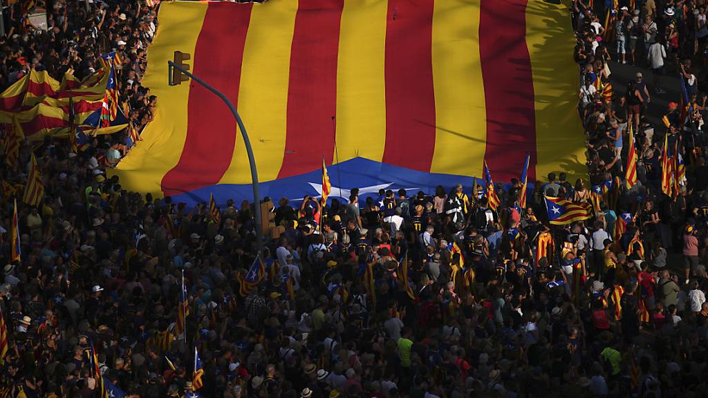 ARCHIV - Demonstranten halten Unabhängigkeitsflaggen zur Feier des katalanischen Nationalfeiertags: Im Ringen um die Regierungsbildung in Spanien haben die Sozialisten ein Abkommen mit einer Separatisten-Partei aus Katalonien erzielt. Foto: Emilio Morenatti/AP/dpa