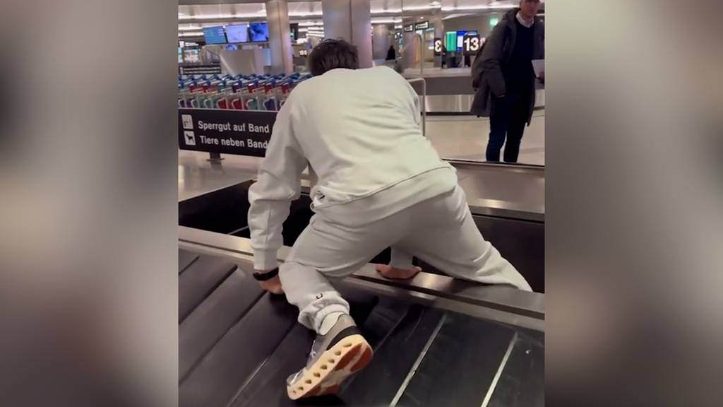 Ungeduldiger Elevator Boy klettert auf Gepäckband am Flughafen Zürich