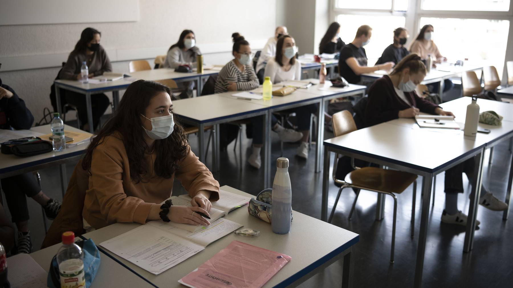 Schueler und Schuelerinnen der Klasse 21-M2.03 der Wirtschaftsschule KV Zuerich folgen Maske tragend dem Geschichtsunterricht, fotografiert am 25. Maerz 2021 in Zuerich.