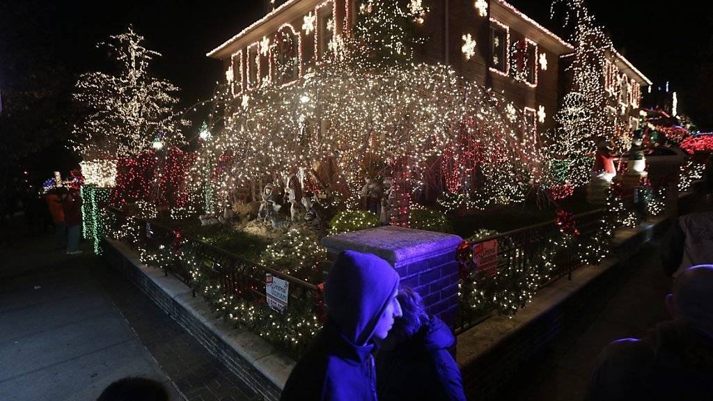 Reich mit Weihnachtsschmuck behangenes Haus in New York: Die weihnächtliche Beleuchtung in den USA verbraucht mehr Strom als arme Länder in einem Jahr nutzen. (Archivbild)