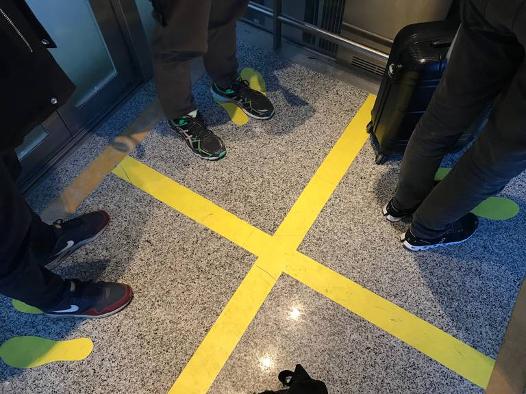 Im Lift, der zur Passkontrolle führt, ist genau markiert, wer wo stehen muss, damit die Abstandsregeln eingehalten werden.