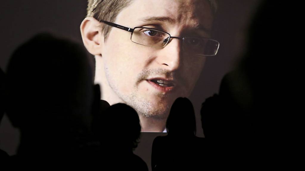 ARCHIV - Edward Snowden ist bei einer Pressevorführung der NDR-Dokumentation «Schlachtfeld Internet - Wenn das Netz zur Waffe wird» auf einer Video-Leinwand zu sehen. Der Whistleblower hat mit der Versteigerung eines digitalen Kunstwerks eine Millionenspende für seine Journalistenstiftung erzielt. Foto: Christian Charisius/dpa