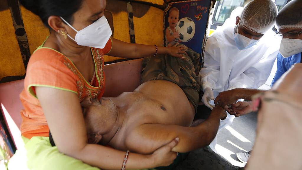 Ein COVID-19-Patient wird in einem Fahrzeug im COVID-19-Regierungskrankenhaus versorgt. Ein Feuer tötete 13 COVID-19-Patienten in einem Krankenhaus im Westen Indiens am 23.04.2021.