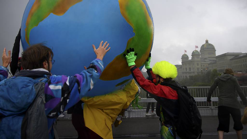 Klimaaktivisten protestieren mit einer aufblasbare Weltkugel während ihrer Aktionswoche Rise up for Change am 25. September 2020 in Bern.