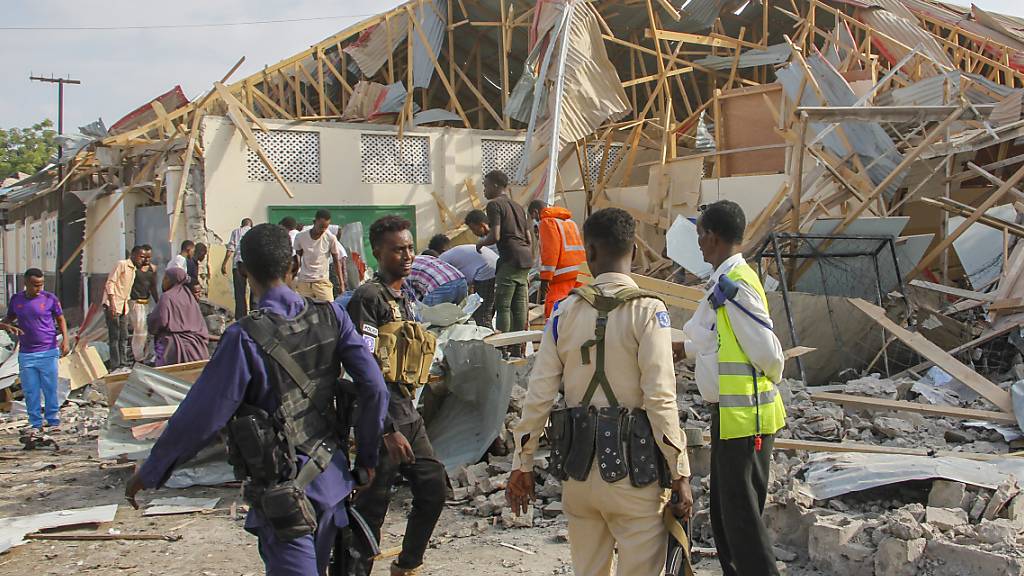 Sicherheitskräfte und Rettungskräfte suchen nach Opfern am Ort einer Explosion. Bei einem Sprengstoffanschlag in Mogadischu, der Hauptstadt des ostafrikanischen Krisenstaats Somalia, sind mindestens sechs Menschen getötet worden. Foto: Farah Abdi Warsameh/AP/dpa