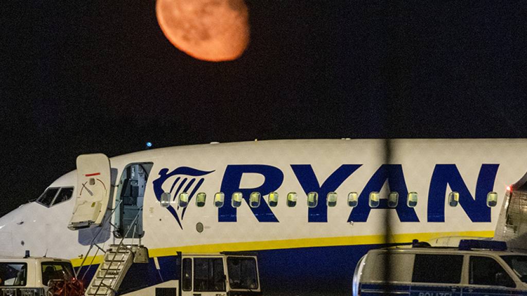 Die Bundespolizei überprüft nach einer außerplanmäßigen Landung einer Ryanair-Maschine am Berliner Hauptstadtflughafen BER das Flugzeug. Im Hintergrund ist der Mond zu sehen. Foto: Christophe Gateau/dpa Foto: Christophe Gateau/dpa