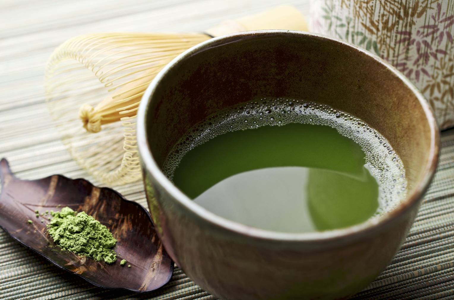 «SEVERAL MORE IN THIS SERIES. Freshly whisked powdered green tea (matcha) with cherrywood scoop, bamboo whisk and tea canister.  Very shallow DOF.»