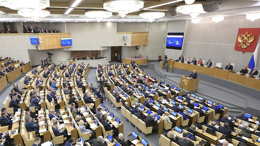 Der russische Ministerpräsident Michail Mischustin, im Hintergrund rechts, spricht vor der Staatsduma, dem Unterhaus des russischen Parlaments in Moskau. Foto: Alexander Astafyev/Pool Sputnik Government/AP/dpa