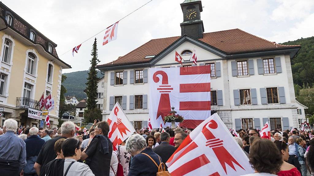 Mit einer Acht-mal-Acht-Meter grossen Fahne am Rathaus in Moutier wollen die Teilnehmer einer Veranstaltung die Zugehörigkeit zum Kanton Jura untermauern.