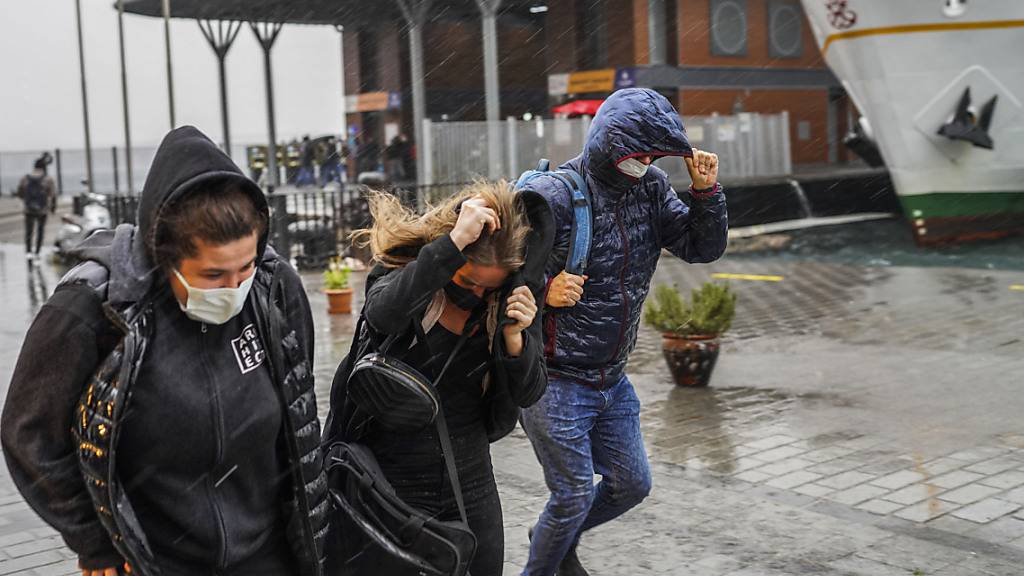 Menschen rennen bei starkem Regen. Ein heftiger Sturm hat am 29.11.21 Istanbul und andere Teile der Türkei heimgesucht, mindestens vier Menschen getötet und in der 15-Millionen-Einwohner-Stadt für Verwüstung gesorgt. Foto: Uncredited/AP/dpa