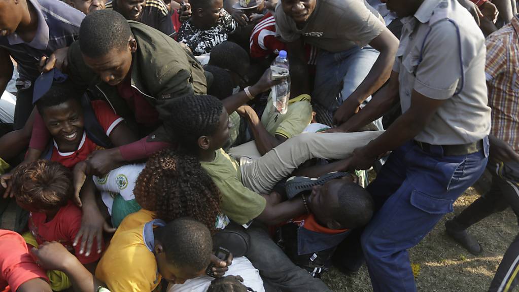 Chaotische Szenen bei der Aufbahrung von Robert Mugabe im Rufaro Stadium in Harare: Ein Polizist versucht Ordnung zu schaffen.