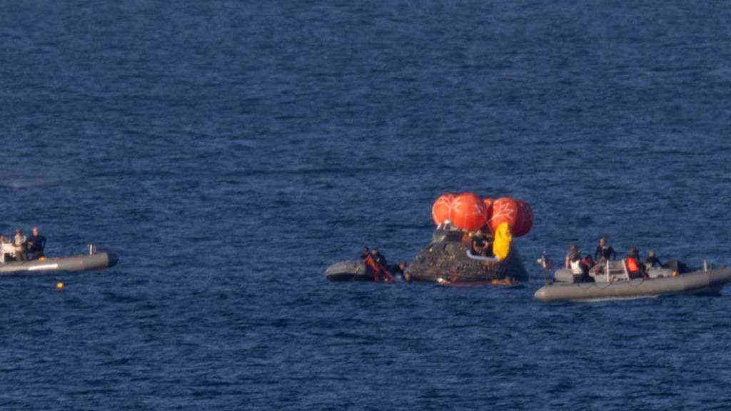 HANDOUT - Auf diesem von der NASA zur Verfügung gestellten Foto arbeiten Bergungsteams an der Sicherung der Orion-Raumkapsel mit der «Artemis II»-Besatzung nach der Wasserung im Pazifischen Ozean vor der Küste Kaliforniens. Foto: Joel Kowsky/NASA/AP/dpa - ACHTUNG: Nur zur redaktionellen Verwendung und nur mit vollständiger Nennung des vorstehenden Credits