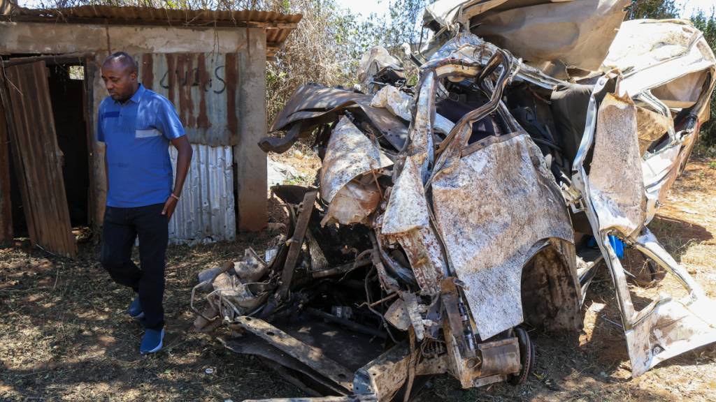 Ein Mann betrachtet die Trümmer eines Kleinbusses, der in der Gegend von Salama im Bezirk Makueni im Osten Kenias in einen Unfall verwickelt war, bei dem alle Insassen ums Leben kamen. Foto: Andrew Kasuku/AP/dpa