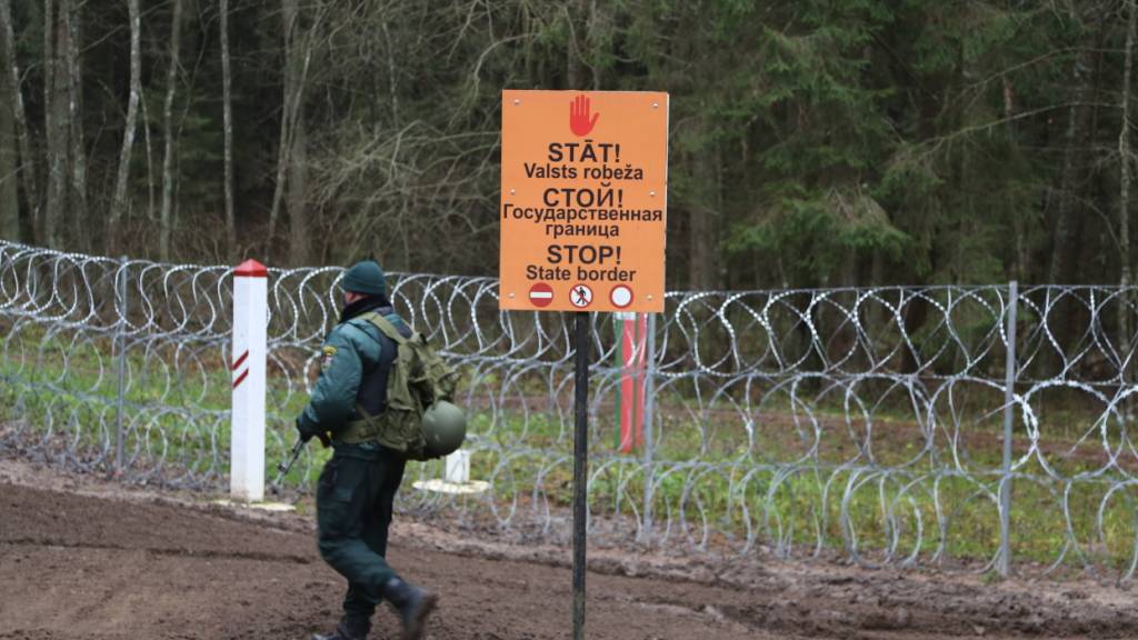 ARCHIV - «Halt - Staatsgrenze» steht in drei Sprachen an der Grenze zu Belarus. In Lettland bleibt der Druck an der EU-Außengrenze zum benachbarten Belarus nach Angaben der Behörden hoch. Foto: Alexander Welscher/dpa