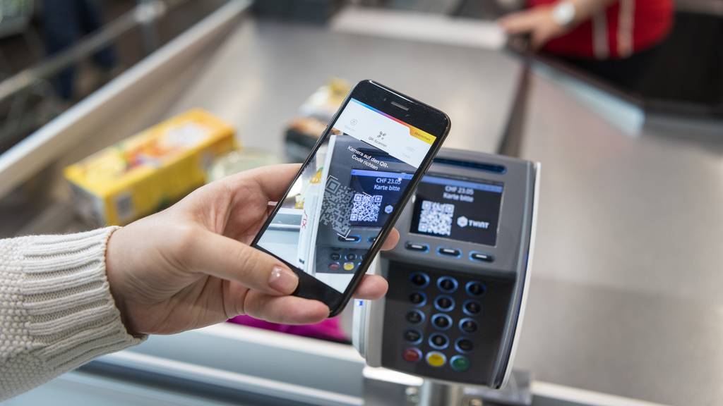 A person uses the Twint cashless payment system via Twint app at the cash register of retailer Spar in Berne, Switzerland, on May 2, 2018.