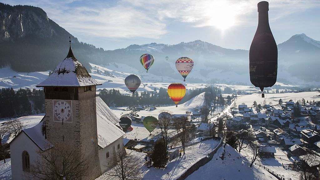 Am Himmel über Château-d'Oex sind anlässlich des 38. Internationalen Ballonfestivals Heissluftballons in den verschiedensten Formen und Farben zu bestaunen.
