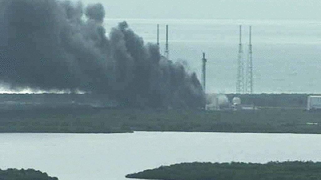 Über dem Gelände der NASA steigt nach der Raketenexplosion eine schwarze Rauchwolke auf.