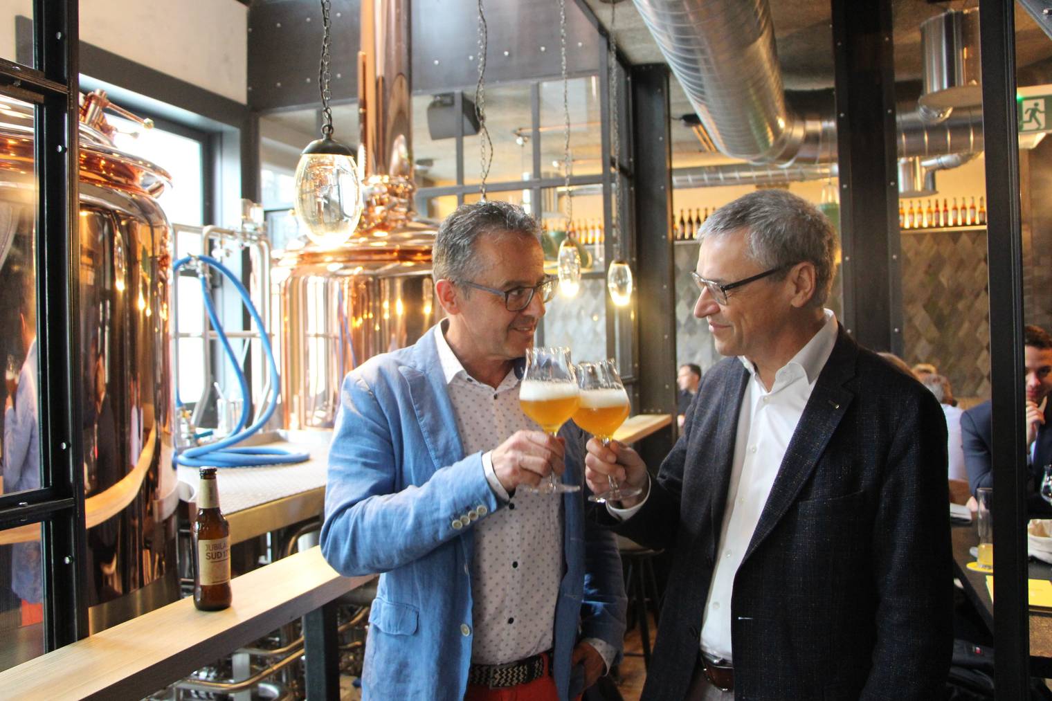 Josef Zweifel (rechts) und Reto Preisig, Vorsitzender der Geschäftsleitung kosten das Jubiläumsbier im brandneuen Brauwerk in St.Gallen. (Bild: Lena Rhyner)