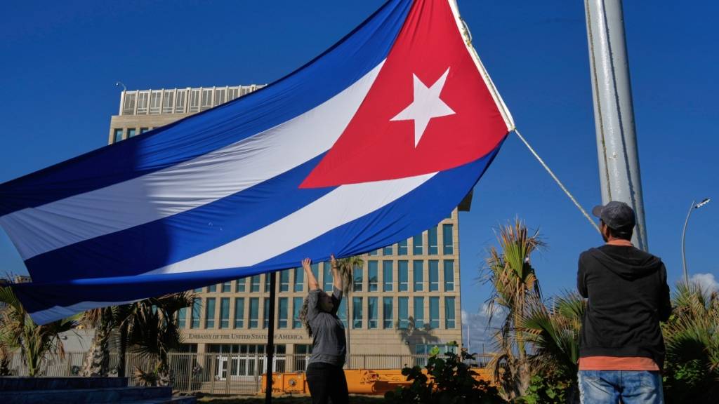 Arbeiter hissen die kubanische Flagge auf Halbmast an der Antiimperialistischen Tribüne nahe der US-Botschaft zum Gedenken an die Kubaner, die zwei Tage zuvor in Caracas (Venezuela) bei der Gefangennahme des venezolanischen Präsidenten Maduro durch US-Streitkräfte ums Leben kamen. Foto: Ramon Espinosa/AP/dpa