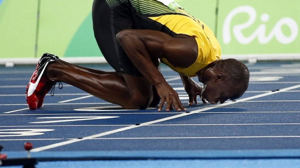 Usain Bolt küsst nach seinem Triumph über 200 m die Ziellinie