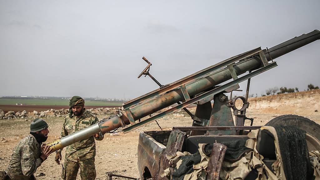 ARCHIV - Von der Türkei unterstützte Soldaten laden einen Raketenwerfer. Die vor fast zehn Jahren in Syrien ausgebrochenen Kämpfe sind 2020 weitgehend abgeklungen. Foto: Anas Alkharboutli/dpa
