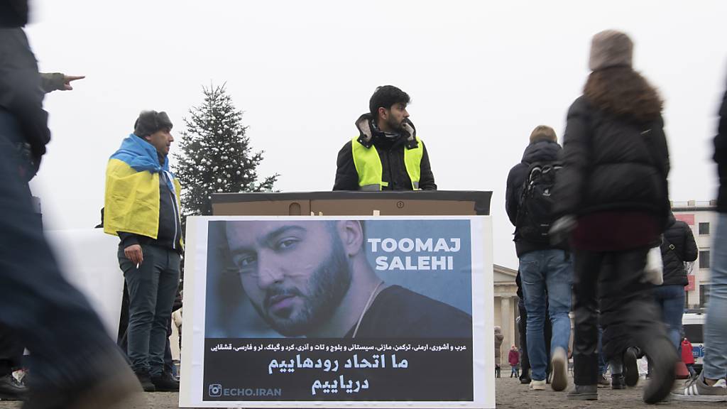 ARCHIV - Ein großes Plakat steht bei einer Protestaktion gegen Irans Staatsführung auf dem Pariser Platz. Es zeigt den iranischen Rapper Toomaj Salehi. Foto: Paul Zinken/dpa