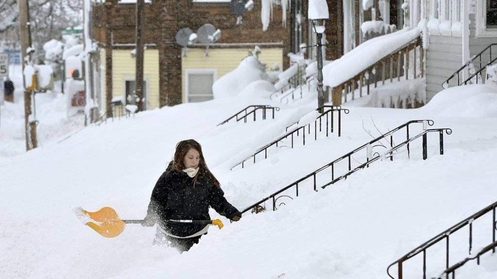 Bis zu den Hüften im Schnee befreit diese Frau in Erie den Hauseingang von den Schneemassen