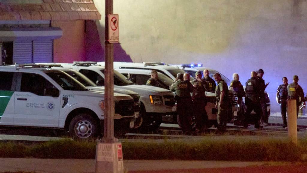 Beamte der US-Zoll- und Grenzschutzbehörde sowie der Metropolitan Police warten auf einem Parkplatz, bevor sie in einer Karawane die Kennedy Street NW im Nordwesten Washingtons entlangfahren. Foto: Jacquelyn Martin/AP/dpa