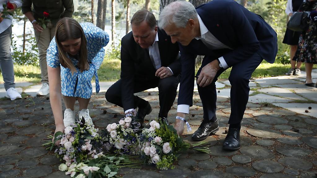 Astrid Hoem, Vorsitzende der AUF,  Stefan Löfven, Ministerpräsident von Schweden, und Jonas Gahr Støre, Vorsitzender der norwegischen Arbeiterpartei, legen Blumen nieder. 