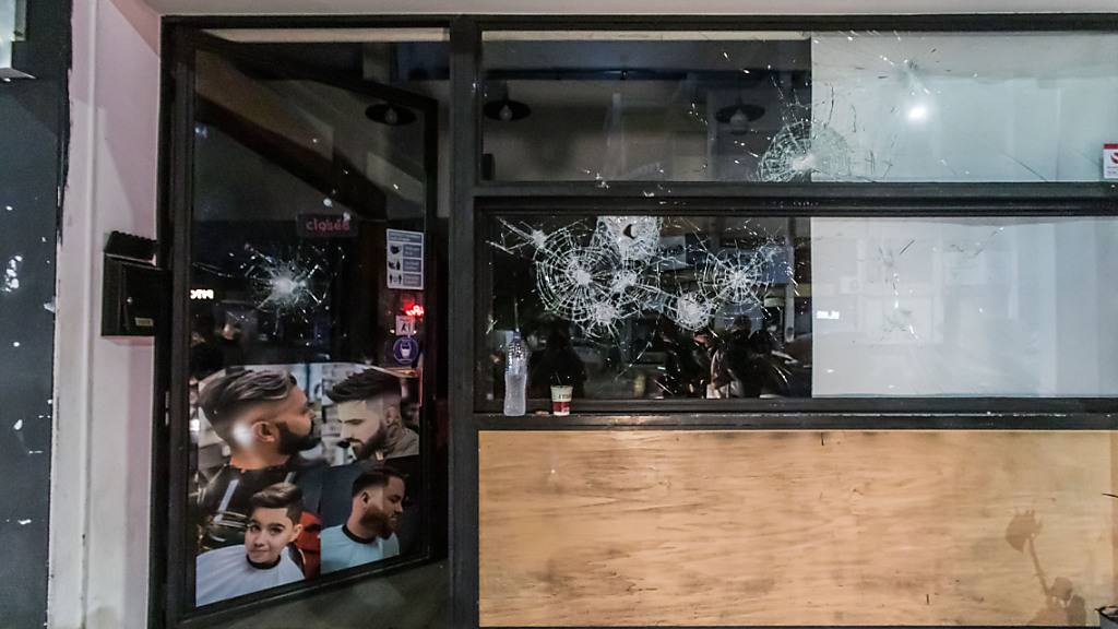 Die Fensterscheibe eines Geschäfts ist zerbrochen. Foto: Kostas Pikoulas/ZUMA Press Wire/dpa