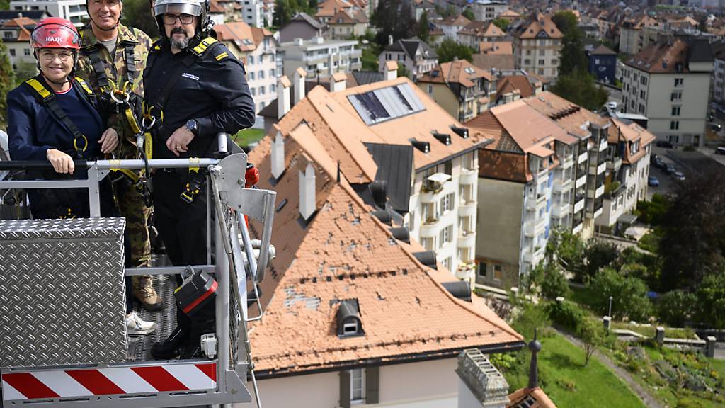 Bundesrätin Viola Amherd will sich in Begleitung von Feuerwehrkommandant Gregory Duc (rechts) und dem Schweizer Armeedivisionär Mathias Tüscher (Mitte) ein Bild von der aktuellen Situation in La Chaux-de-Fonds NE machen, die am 24. Juli von einem heftigen Sturm heimgesucht wurde.