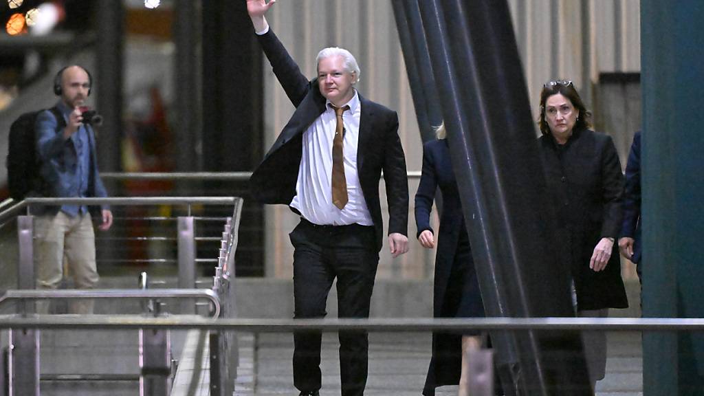 WikiLeaks-Gründer Julian Assange winkt nach der Landung auf dem RAAF-Luftwaffenstützpunkt Fairbairn in Canberra. Assange ist an Bord eines Charterflugzeugs in sein Heimatland Australien zurückgekehrt, Stunden nachdem er sich im Rahmen einer Einigung mit den Staatsanwälten des Justizministeriums schuldig bekannt hatte, US-Militärgeheimnisse beschafft und veröffentlicht zu haben. Foto: Mick Tsikas/AAP/dpa