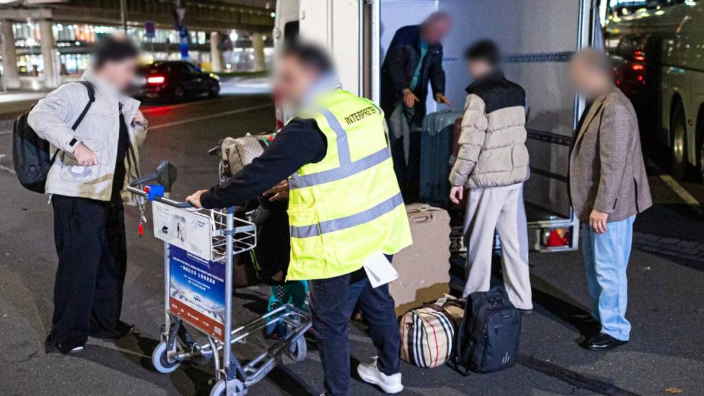 ARCHIV - Menschen aus Afghanistan, die zuvor mit einem Flugzeug auf dem Flughafen Hannover-Langenhagen gelandet sind, stehen vor dem Flughafen und verladen ihr Gepäck. Ein finanzielles Angebot der Bundesregierung für einen Verzicht auf Aufnahme in Deutschland haben nur wenige der betroffenen Afghaninnen und Afghanen angenommen. Foto: Moritz Frankenberg/dpa - ACHTUNG: Person(en) wurde(n) aus rechtlichen Gründen gepixelt