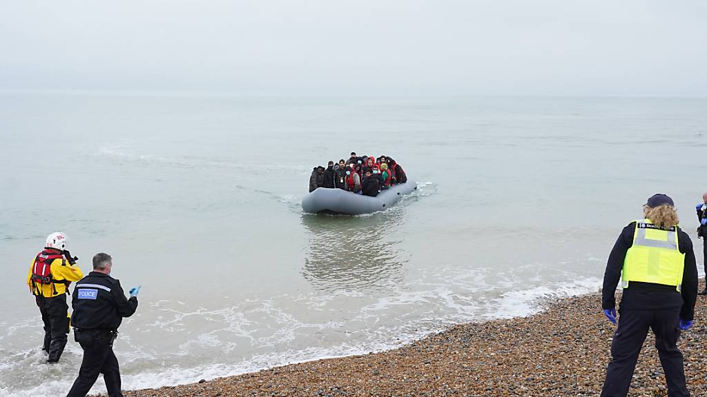 Ein Schlauchboot mit mutmaßlichen Migranten kommt am Strand von Dungeness an. Großbritannien will angesichts der Rekordzahl illegaler Migranten härtere Regeln für Asylsuchende einführen. Das geht aus einem Bericht der Zeitung «Telegraph» am Samstag mit Bezug auf die Innenministerin Patel hervor. Foto: Gareth Fuller/PA Wire/dpa