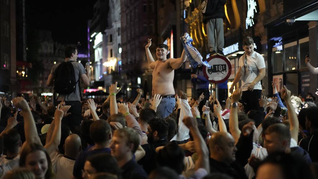 England fans react in the center of London after England won the Euro 2020 soccer championship semifinal match between England and Denmark played at Wembley Stadium in London, Wednesday, July 7, 2021.