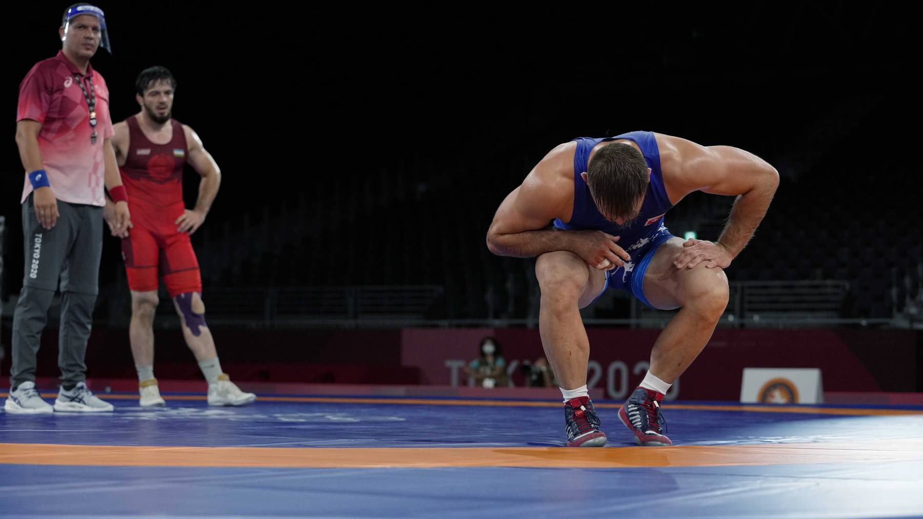 Switzerland's Stefan Reichmuth kneels after he lost against Uzbekistan's Shapiev Jayrail during the men's 86kg Freestyle wrestling repechage match at the 2020 Summer Olympics, Thursday, Aug. 5, 2021, in Tokyo, Japan.
