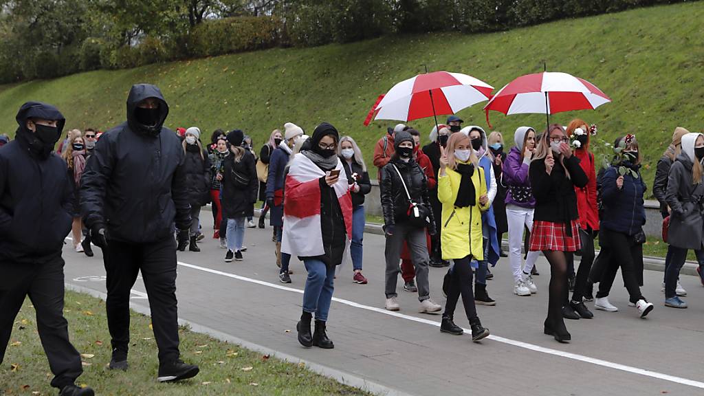 Polizisten in Zivil begeiten belarussische Frauen mit Mund-Nasen-Schutz bei einem Protest der Opposition in Minsk.