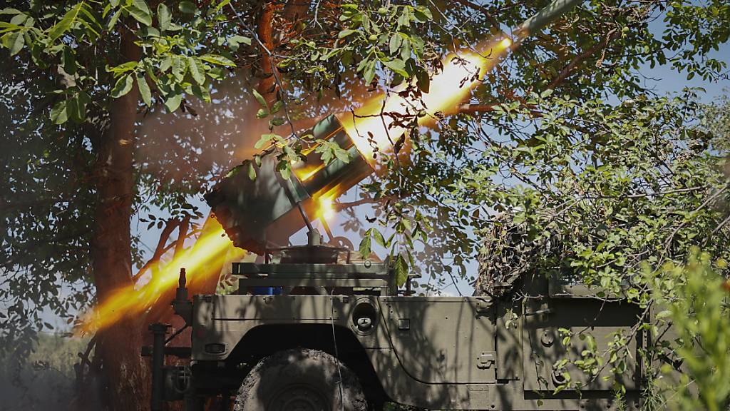 Ukrainische Soldaten feuern einen Mehrfachraketenwerfer in Richtung der russischen Stellungen. Foto: Roman Chop/AP/dpa