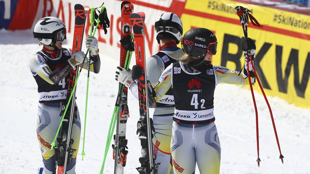 Norway's Kristina Riis Johannessen, right, and Norway team celebrate during an alpine ski, mixed World Cup team parallel event, in Lenzerheide, Switzerland, Friday, March 19, 2021.