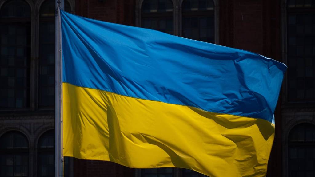 ARCHIV - Eine Flagge der Ukraine weht im Wind vor dem Roten Rathaus. Foto: Monika Skolimowska/dpa