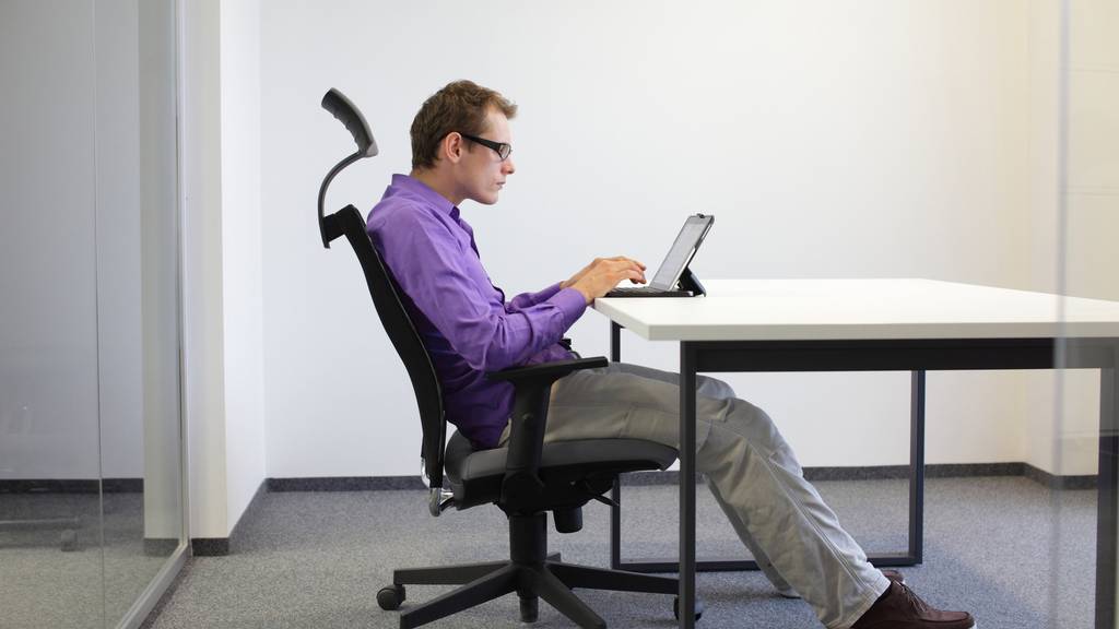 Sitting posture at tablet, tired business man on chair in his office
