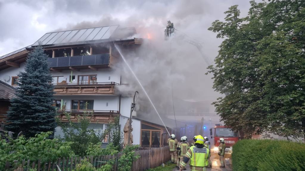 Feuerwehrkräfte löschen ein Feuer in einem Hotel in St. Johann. Foto: Zoom.Tirol/APA/dpa