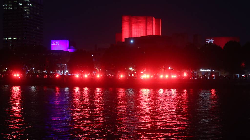 Das Nationaltheater in London und die South Bank werden rot beleuchtet, um auf über eine Million Arbeitsplätze in der Unterhaltungsindustrie aufmerksam zu machen, die nach dem Ausbruch des Coronavirus ohne finanzielle Unterstützung sind. Foto: Yui Mok/PA Wire/dpa