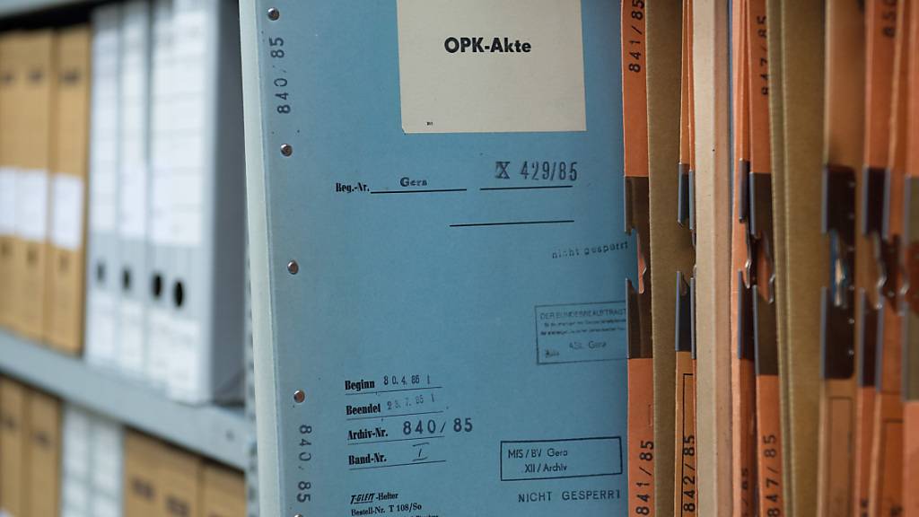 ARCHIV - Eine Stasi-Akte mit der Aufschrift OPK-Akte (Operative Personenkontrolle) steckt in der BStU-Außenstelle in Gera (Thüringen) in einem Regal. Foto: Sebastian Kahnert/dpa-Zentralbild/dpa