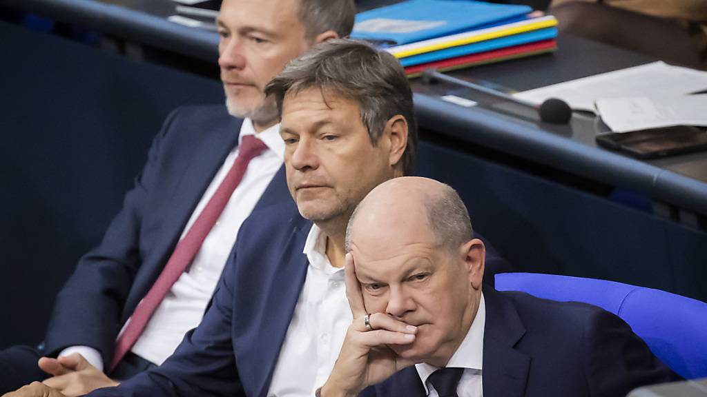 ARCHIV - Bundeskanzler Olaf Scholz (SPD, r-l), Wirtschaftsminister Robert Habeck (Bündnis 90/Die Grünen) und Finanzminister Christian Lindner (FDP) verfolgen im Plenum des Deutschen Bundestages die Debatte. Foto: Christoph Soeder/dpa