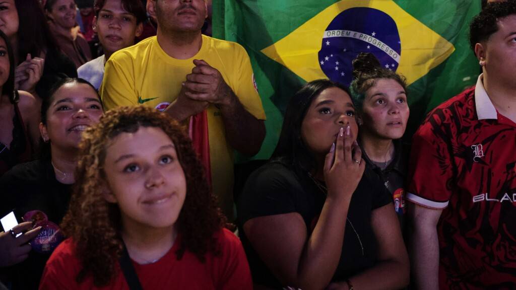 Anhänger von Präsident Lula da Silva, der sich um eine Wiederwahl bewirbt, reagieren während einer Versammlung, bei der auf die Wahlergebnisse gewartet wird. Foto: Ettore Chiereguini/AP/dpa