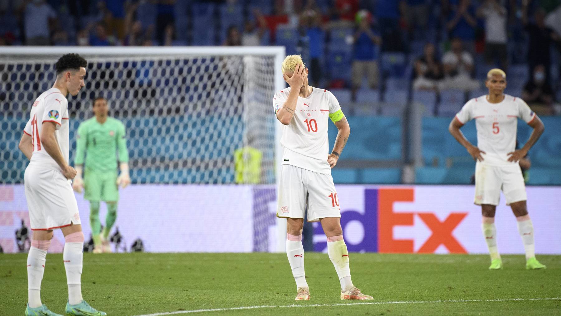 From left, Switzerland's midfielder Ruben Vargas, Switzerland's midfielder Granit Xhaka and Switzerland's defender Manuel Akanji, are disappointed after conceding Italy's third goal during the Euro 2020 soccer tournament group A match between Italy and Switzerland at the Olympic stadium, in Rome, Italy, Wednesday, June 16, 2021.